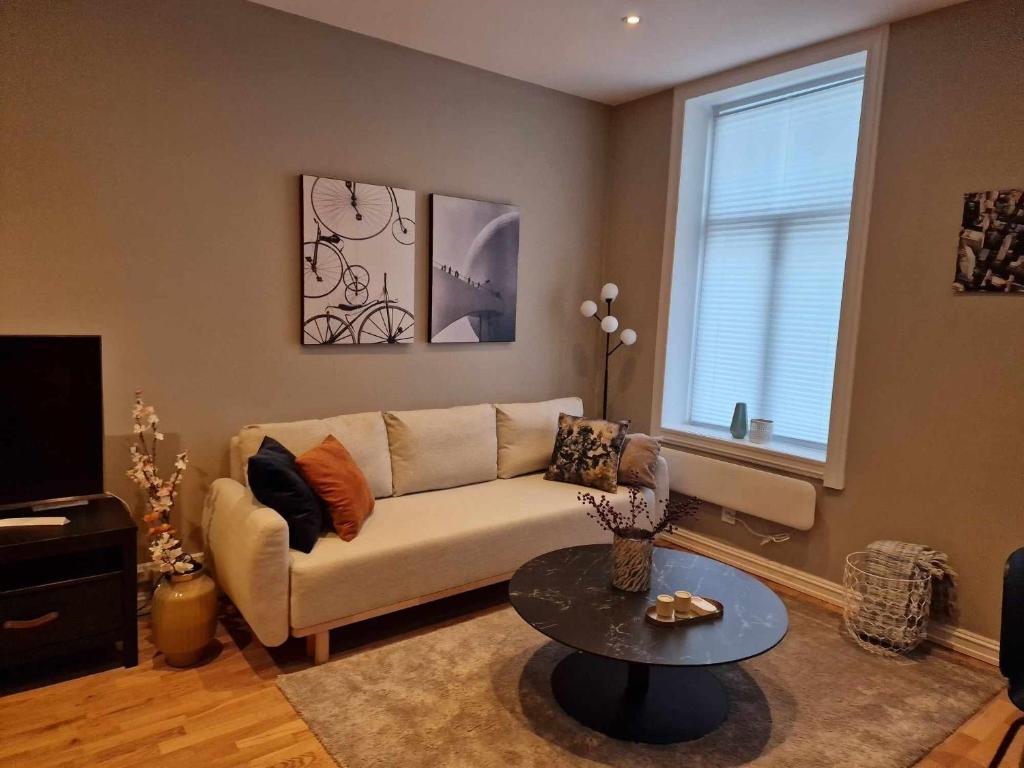 a living room with a couch and a table at Central and modern in Oslo
