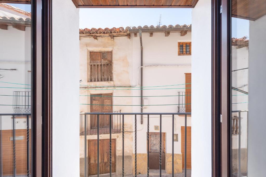 an open window with a view of a building at Apartamento Casa El Cojo 1a in Alcalá de la Selva