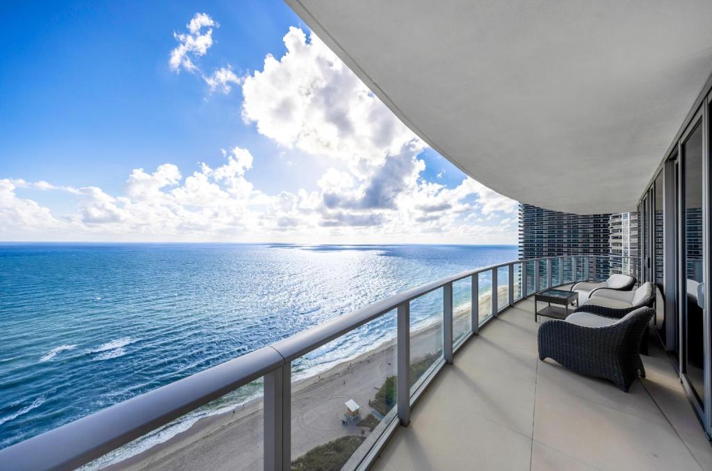 a view of the ocean from the balcony of a building at Stunning Beachfront 3-Bedroom Corner Residence in Hollywood