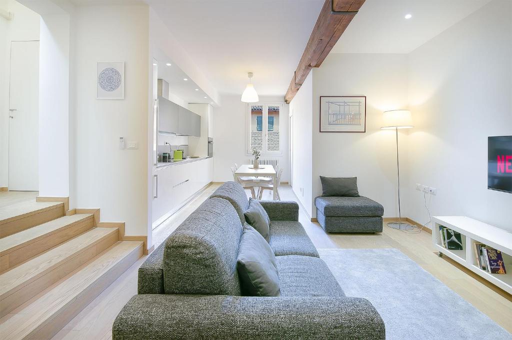 a living room with a couch and two chairs and a table at San Vitale 5 Stelle - Central Luxury Apartment in Bologna
