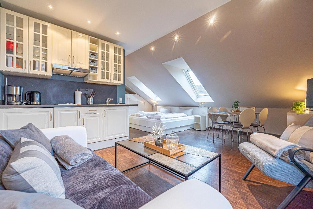 a living room with a couch and a table at fewo1846 Strandresidenz Wassersleben - Strandkoje - komfortables Studioapartment mit Meerblick am Strand in Harrislee