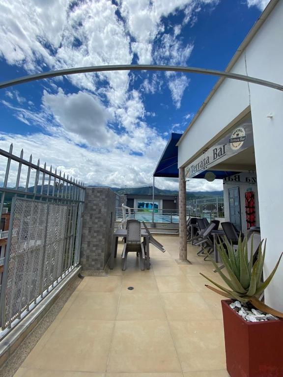 a balcony with tables and chairs on a building at Hotel Suite Royal in Melgar