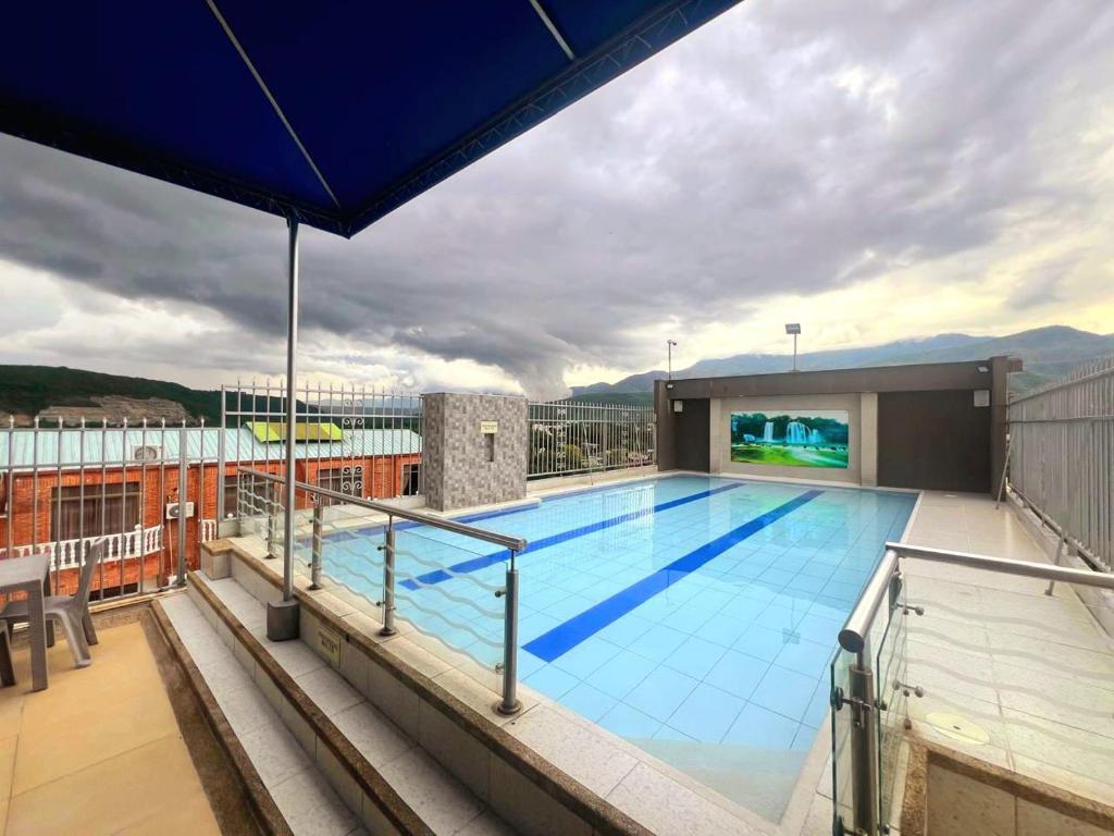 a swimming pool on the roof of a building at Hotel Suite Royal in Melgar