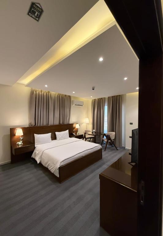 a bedroom with a large bed and a television at North paradise hotel in Irbid