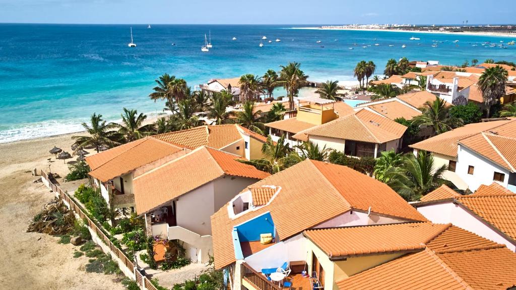 an aerial view of a beach with houses and the ocean at T1 Vista Mar - Porto Antigo 3 in Santa Maria