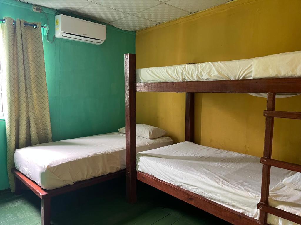 A bed or beds in a room at Hostal Cay