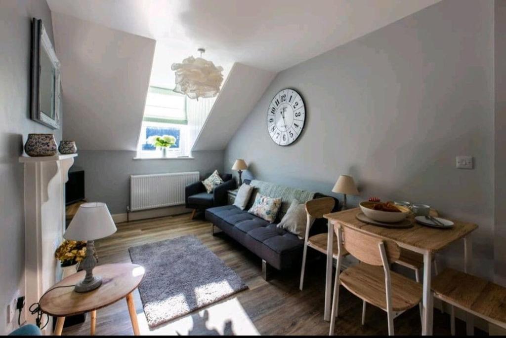 a living room with a couch and a table at Stylish 1 bed flat on the Hoe - Mayflower in Plymouth