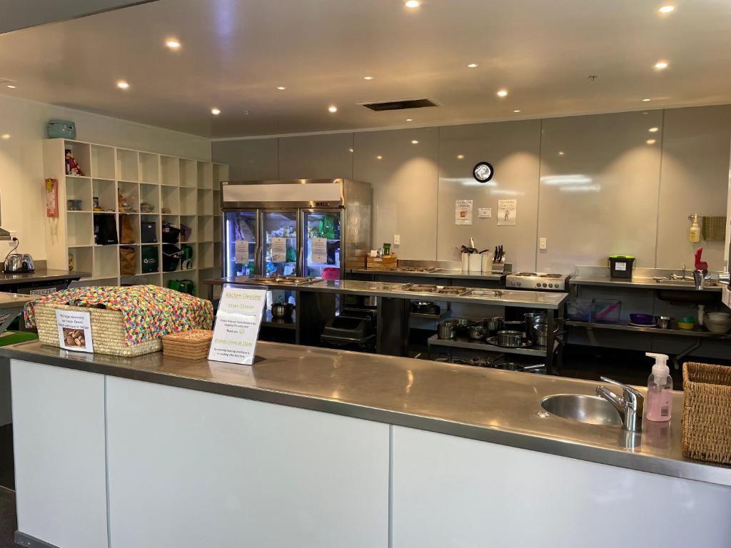 a large kitchen with a counter and a sink at YHA Nelson in Nelson