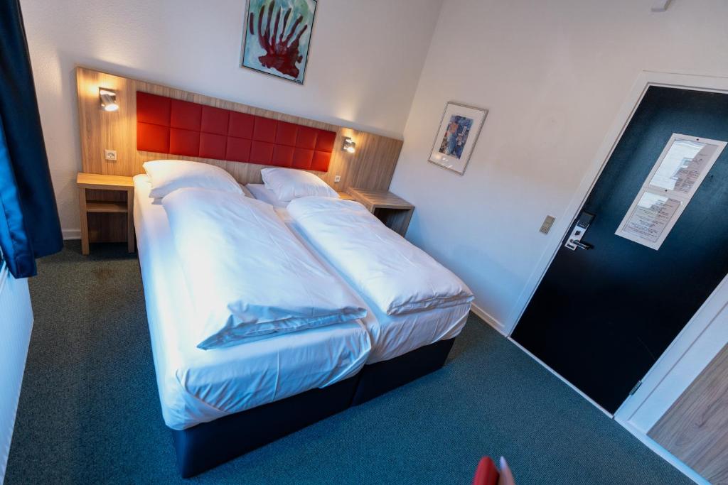 Ένα ή περισσότερα κρεβάτια σε δωμάτιο στο Prinsen Hotel