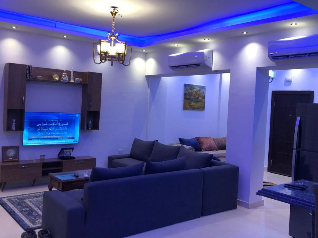 a living room with a couch and a tv at Sharm El Sheikh nema downtown apartment in Sharm El Sheikh