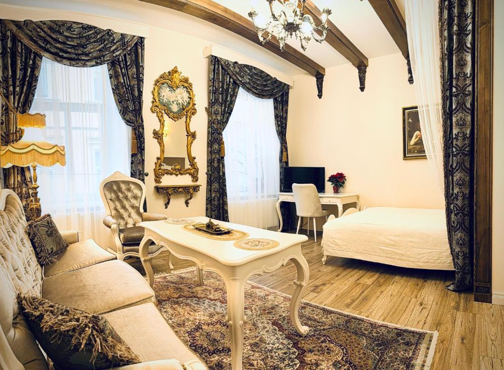 a living room with a couch and a table at Noble Apartments in Vilnius