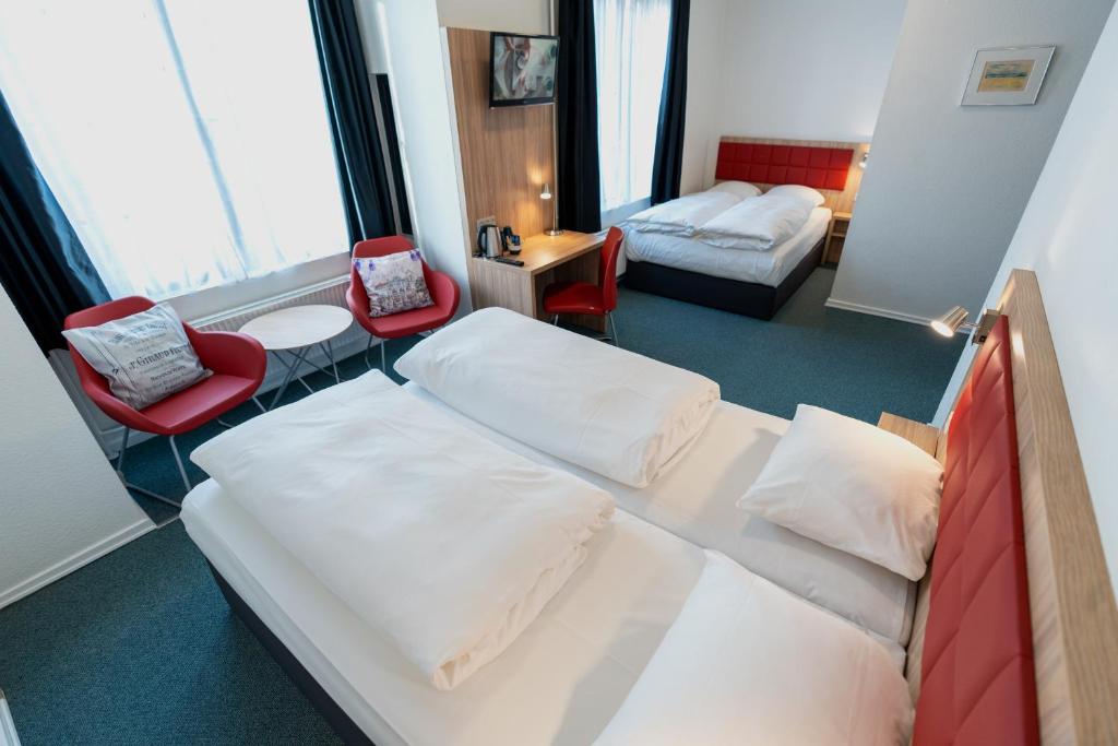 Ένα ή περισσότερα κρεβάτια σε δωμάτιο στο Prinsen Hotel