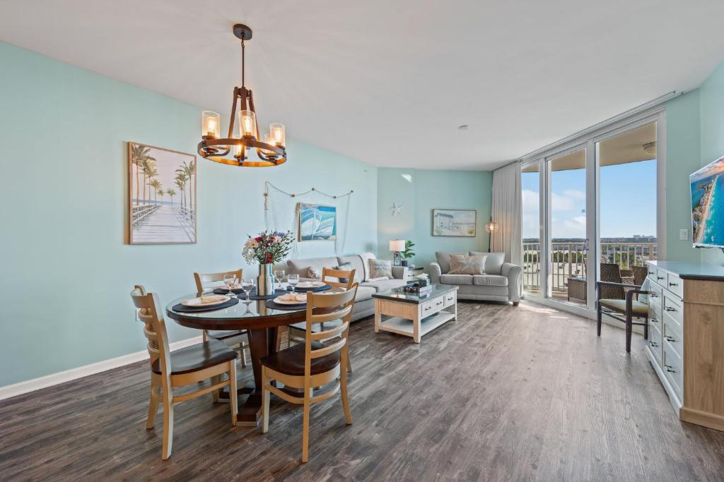 a dining room and living room with a table and chairs at 5 Star Resort 11th Fl Stunning Sunrise 2BR 2BA King Suite,Pools ,Shuttle or Walk to Beach in Destin