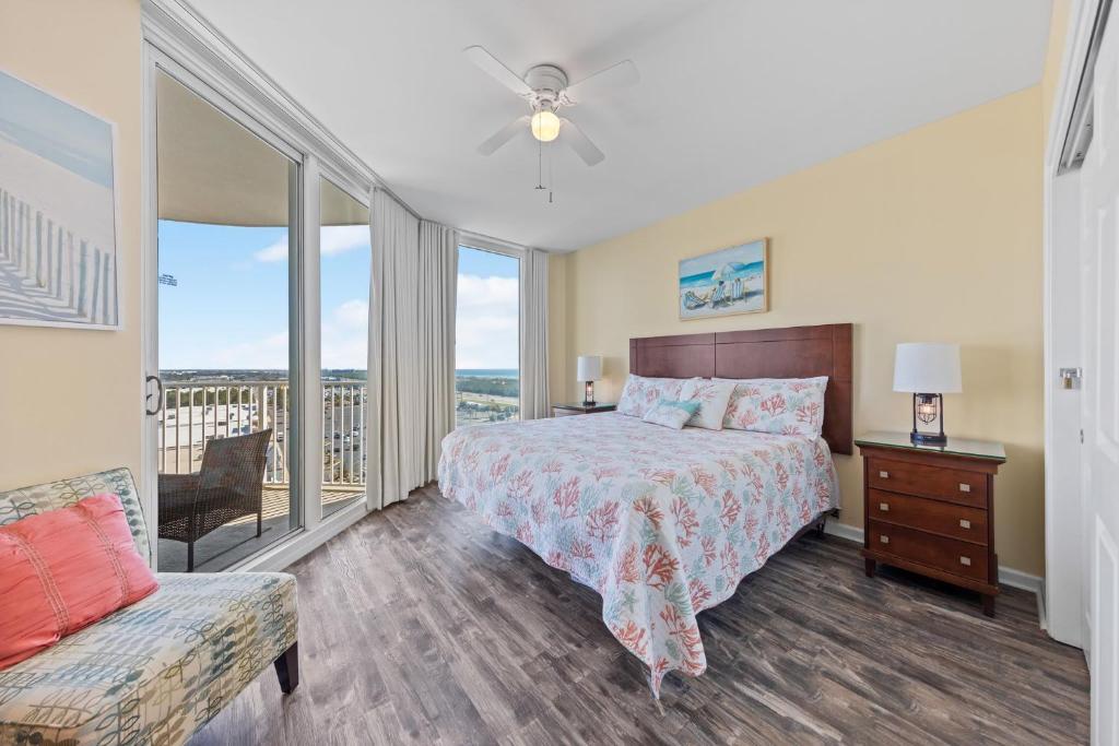 a bedroom with a bed and a balcony at 5 Star Resort 11th Fl Stunning Sunrise 2BR 2BA King Suite,Pools ,Shuttle or Walk to Beach in Destin