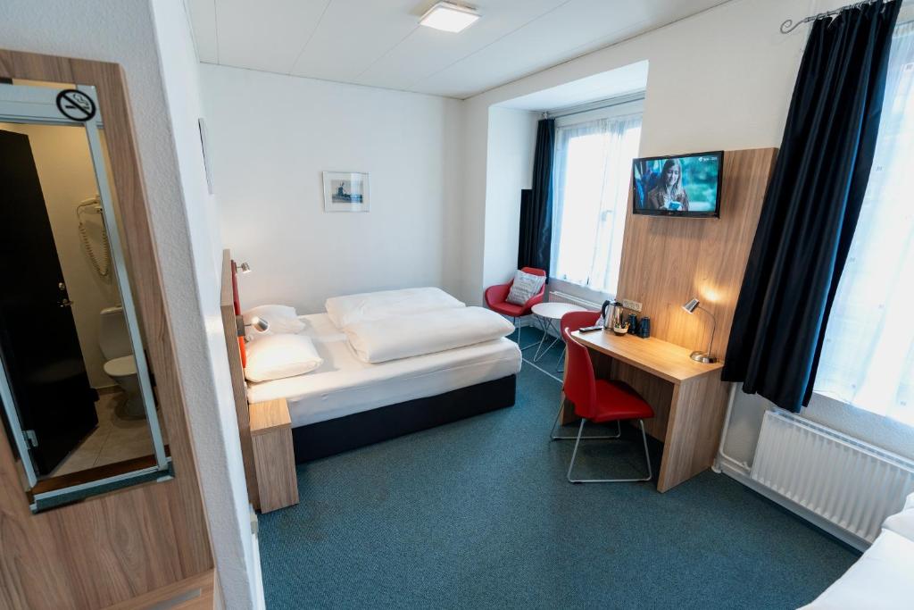 Ένα ή περισσότερα κρεβάτια σε δωμάτιο στο Prinsen Hotel