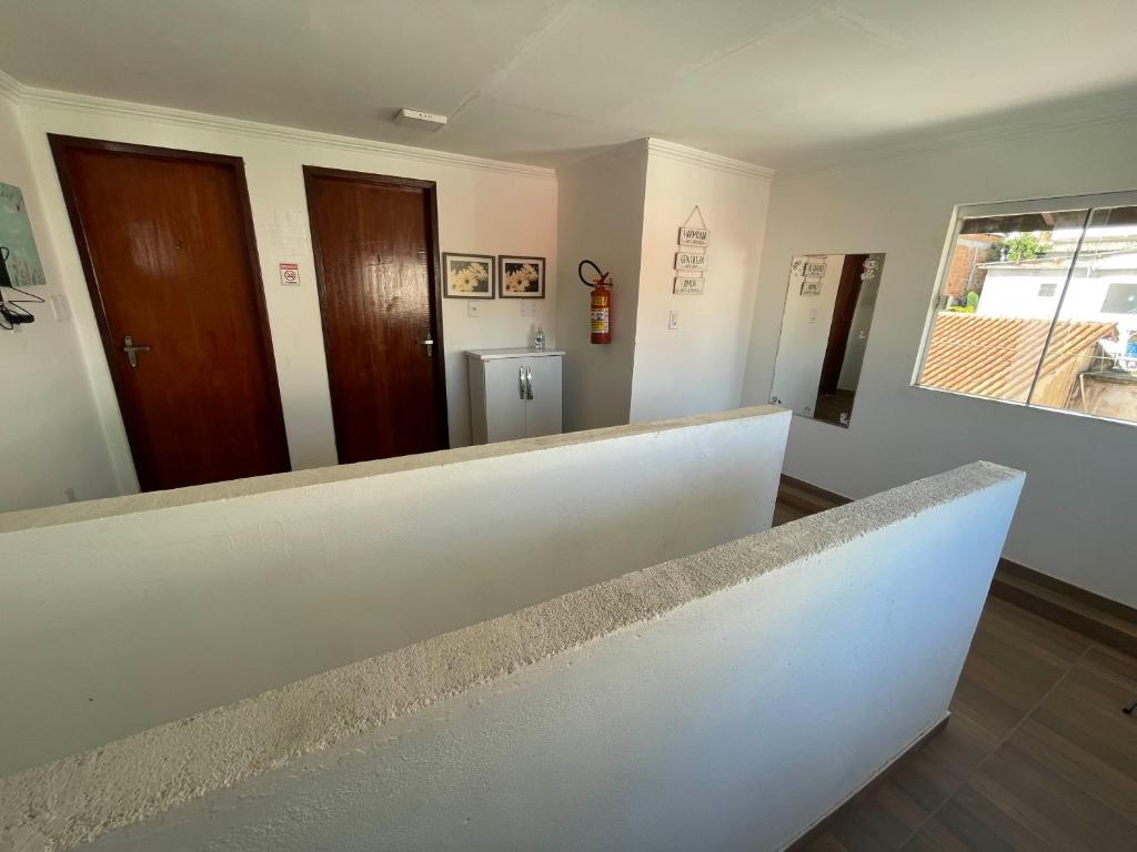 a white counter in a room with two doors at Suítes Sol e Mar - Arraial do Cabo na Praia dos Anjos in Arraial do Cabo