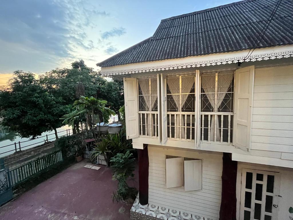 a house with a large window on the side of it at Once in Lampang Guesthouse in Lampang