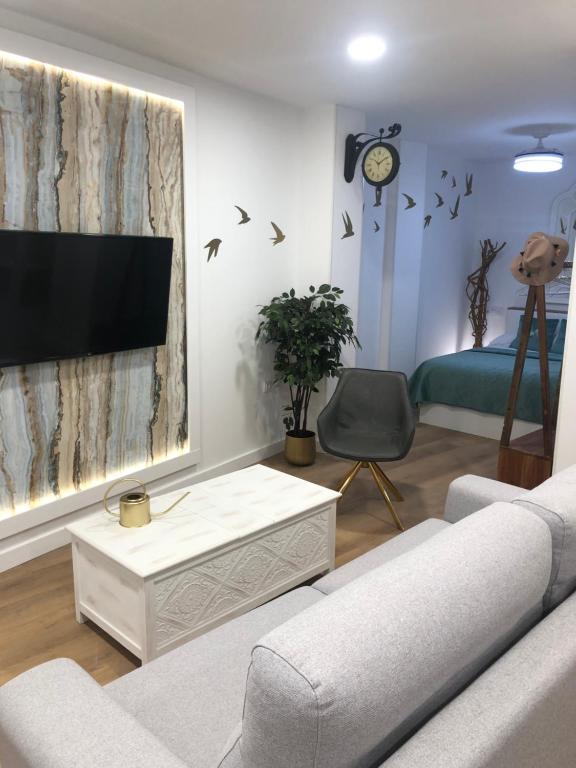 a living room with a couch and a tv at La Casa de la Abuela in Jaén