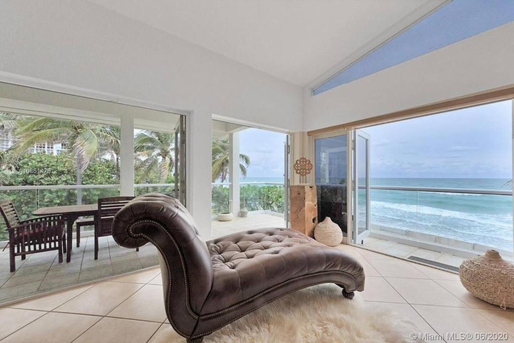 Una sala de estar con un sofá y vista al mar. en Gorgeous 4-bedroom beach space, en Hollywood