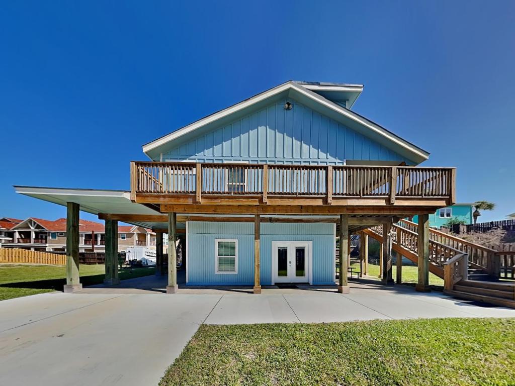 a house with a deck on top of it at The Hidden Porpoise in Port Aransas