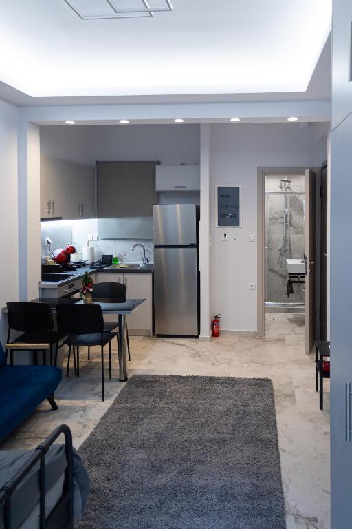 a kitchen and dining room with a table and chairs at Elario studio in Larisa