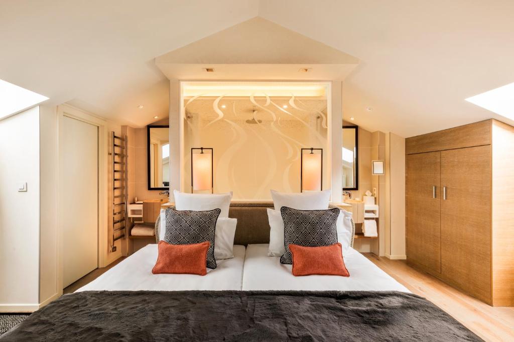a bedroom with a large bed with two pillows at Hôtel Mont-Blanc Chamonix in Chamonix