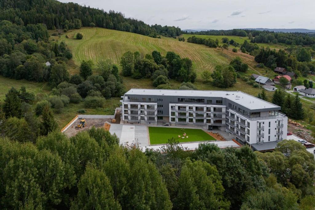 an aerial view of a building in a field at Brezovina Apartments Oravské Veselé - ORAVA in Veselé