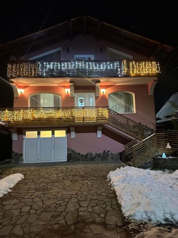 a house with christmas lights on the front of it at Alex House in Borsa