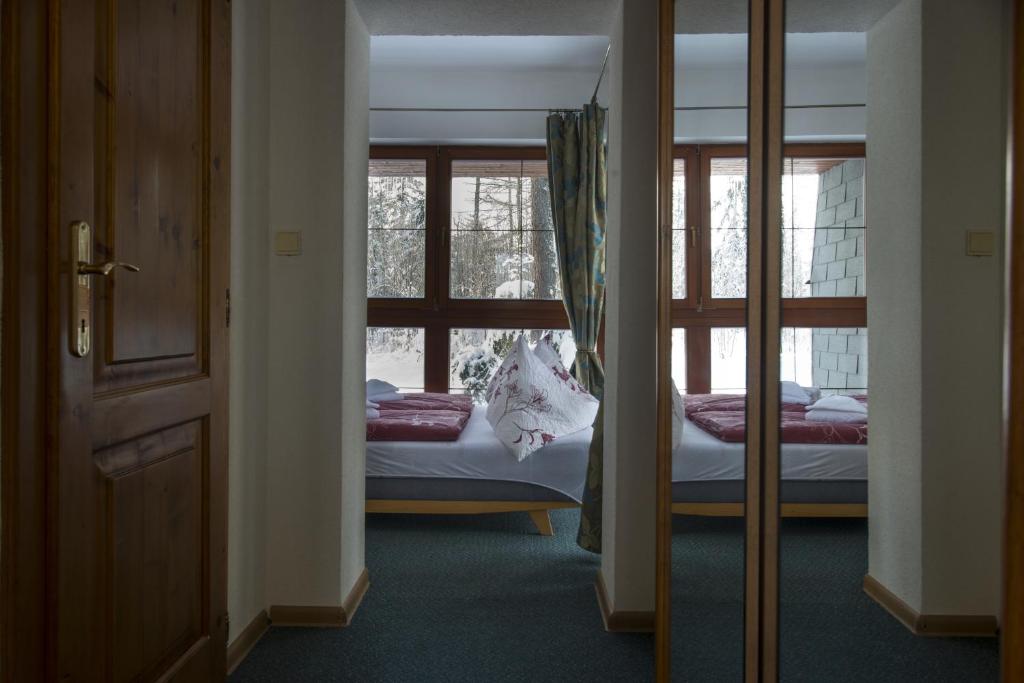 Postel nebo postele na pokoji v ubytování Penzión Pleso