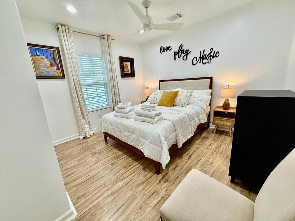 a bedroom with a bed and a sign that says tax pile advice at The Blue Luzon Cozy Bungalow 5 min Downtown in Houston