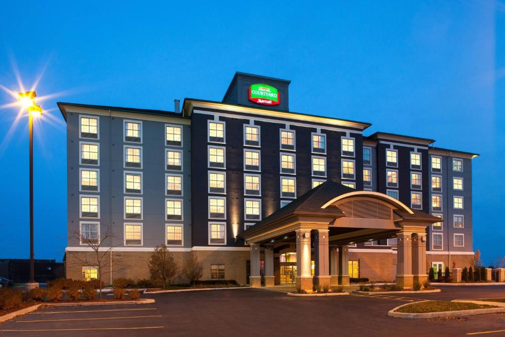 a hotel building with a clock on top of it at Courtyard by Marriott London in London