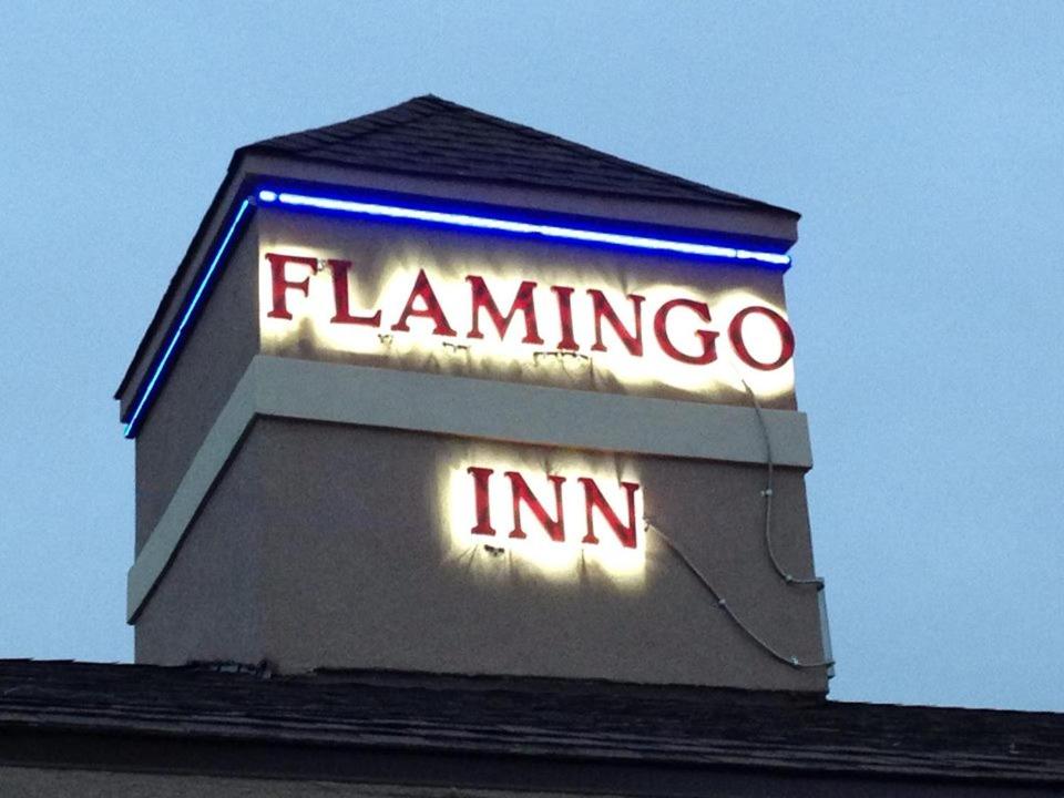 a sign for a flamingo inn on top of a building at Flamingo Inn in Elk City