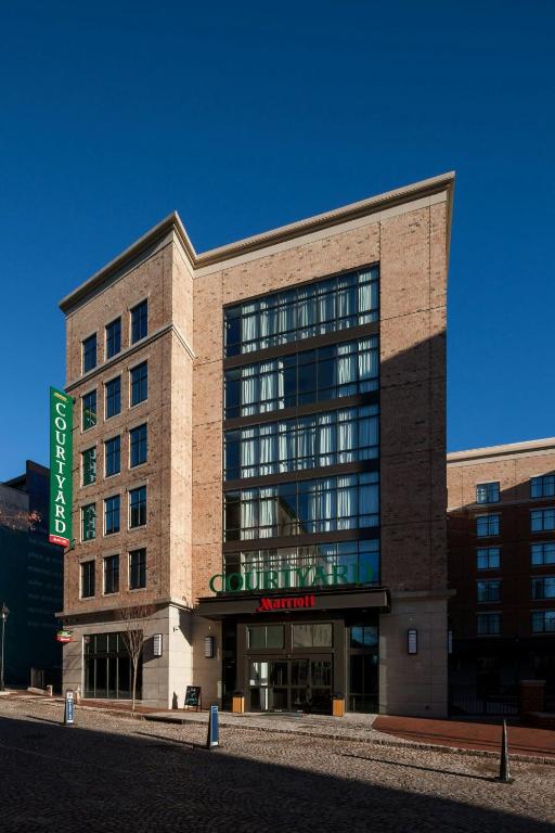 a large building with a sign in front of it at Courtyard by Marriott Richmond Downtown in Richmond