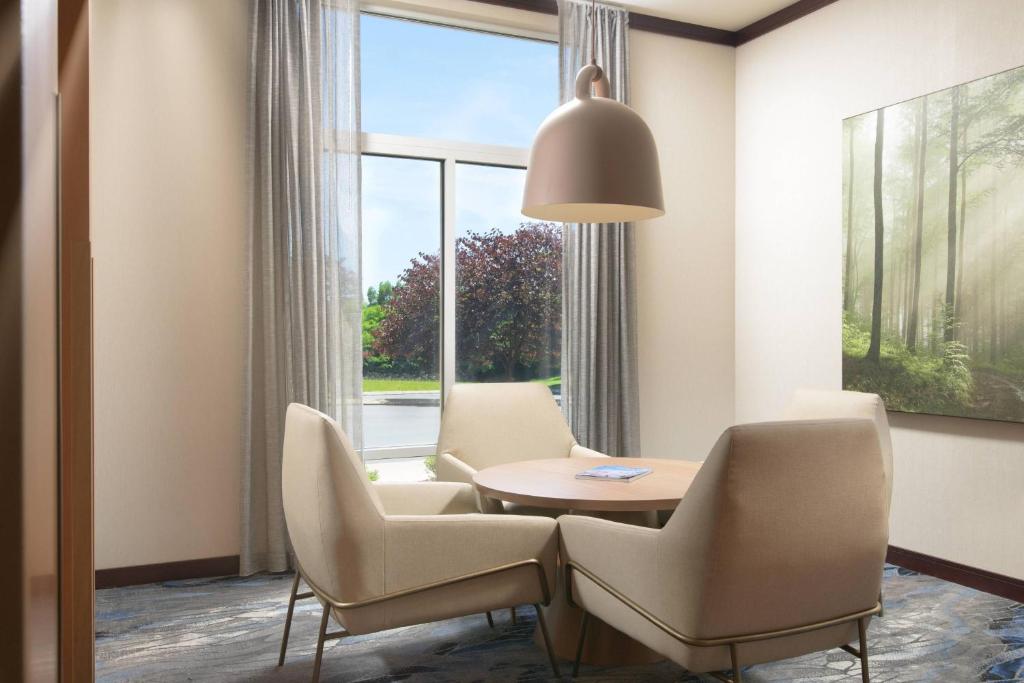 a dining room with a table and chairs and a window at Fairfield Inn & Suites Chattanooga I-24/Lookout Mountain in Chattanooga