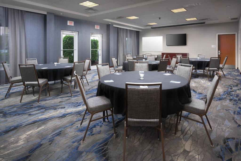 a conference room with tables and chairs and a screen at Fairfield Inn & Suites Chattanooga I-24/Lookout Mountain in Chattanooga