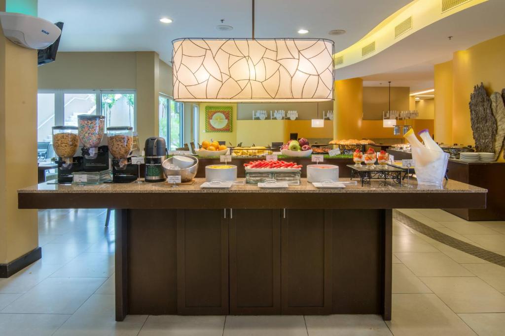 a large island in a restaurant with food on it at Courtyard by Marriott San Jose Airport Alajuela in Alajuela City