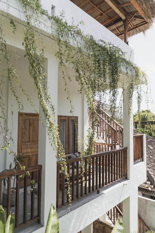 a balcony of a house with plants on it at Nalua Boutique Hotel in Kuta Lombok