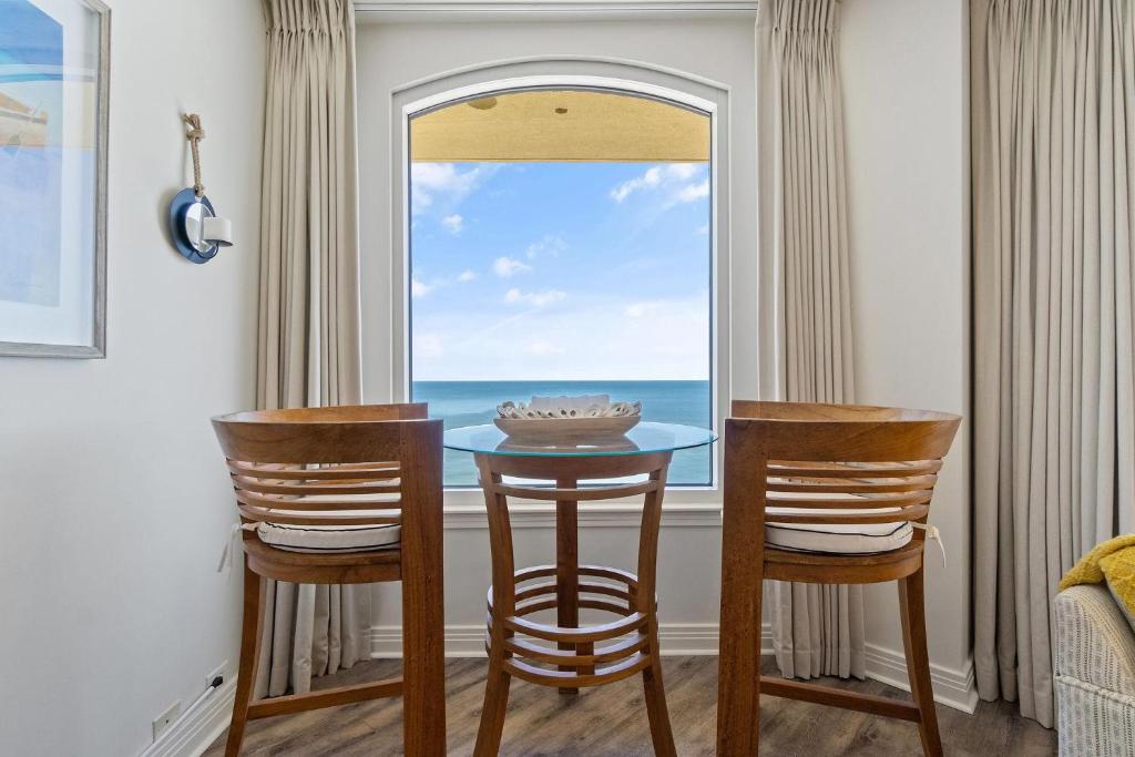 a dining room with a table and two chairs and a window at Beach Colony East 17B-Penthouse in Perdido Key