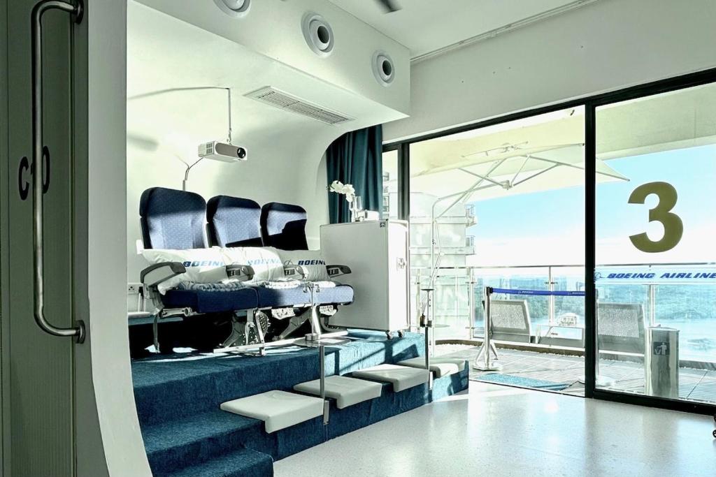 a therapy room with three chairs and a window at Dooga Ins-Boeing 777X Seaview in Johor Bahru