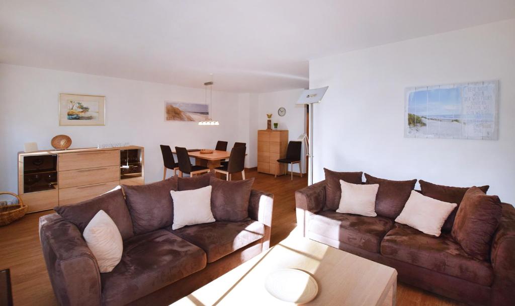 a living room with a couch and a table at Am Darßwald Haus 2 1 in Prerow