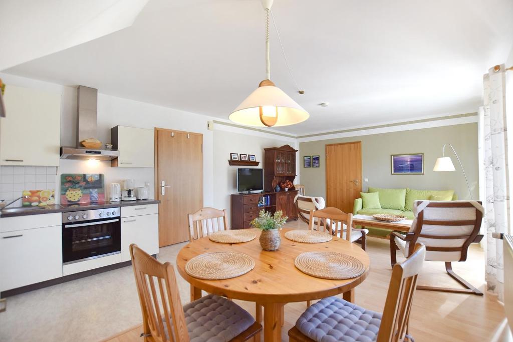a kitchen and dining room with a table and chairs at Waldstr 7 Wo 6 in Prerow