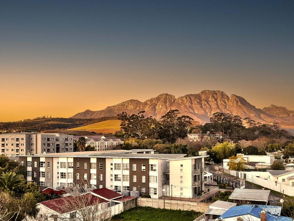 a city with buildings and mountains in the background at WINK Aparthotel Quiver Tree in Stellenbosch