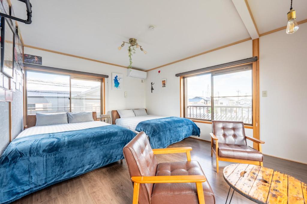 Postel nebo postele na pokoji v ubytování Yokkaichi Guest House