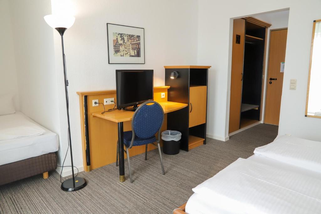 Postel nebo postele na pokoji v ubytování Hotel am Südtor