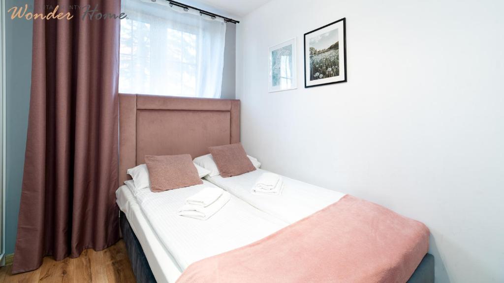 Posteľ alebo postele v izbe v ubytovaní Wonder Home - Apartamenty położone blisko deptaka, licznych restauracji i sklepów