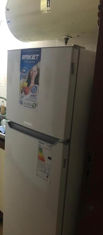 a refrigerator with a poster on the top of it at San Bernardo in San Bernardo