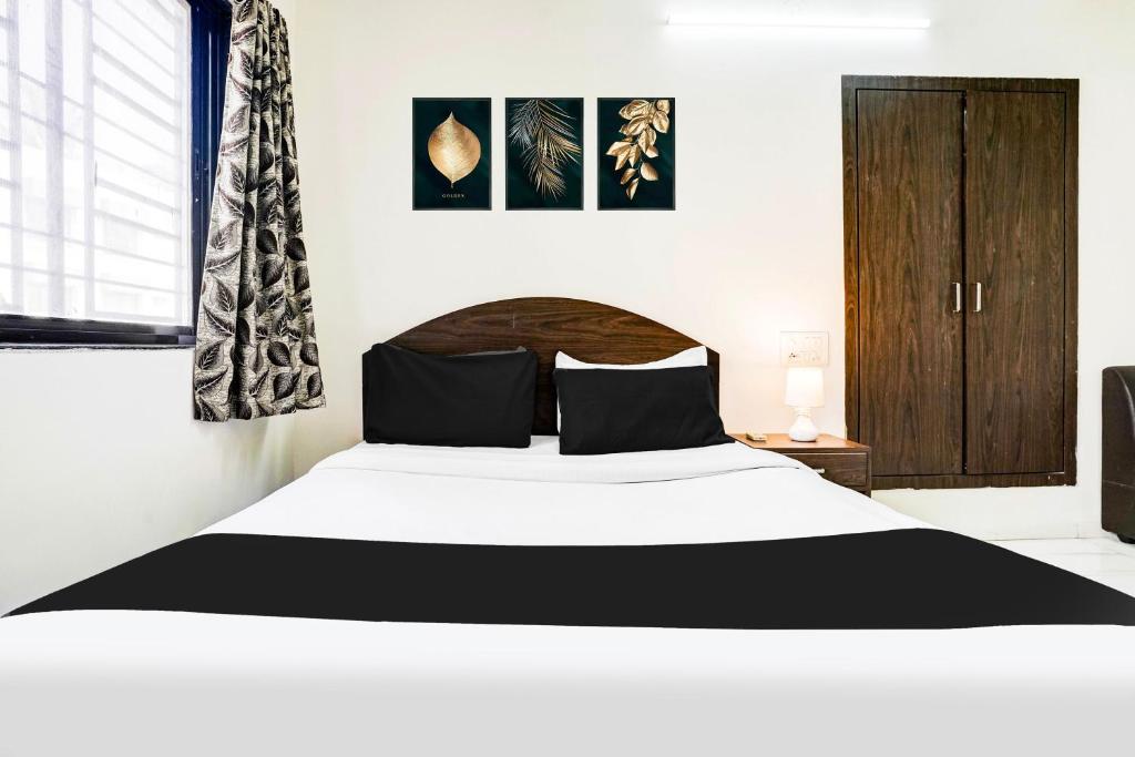 Postel nebo postele na pokoji v ubytování Hotel O Nashik Near Vijay Mamta Theatre Formerly Sahara Inn