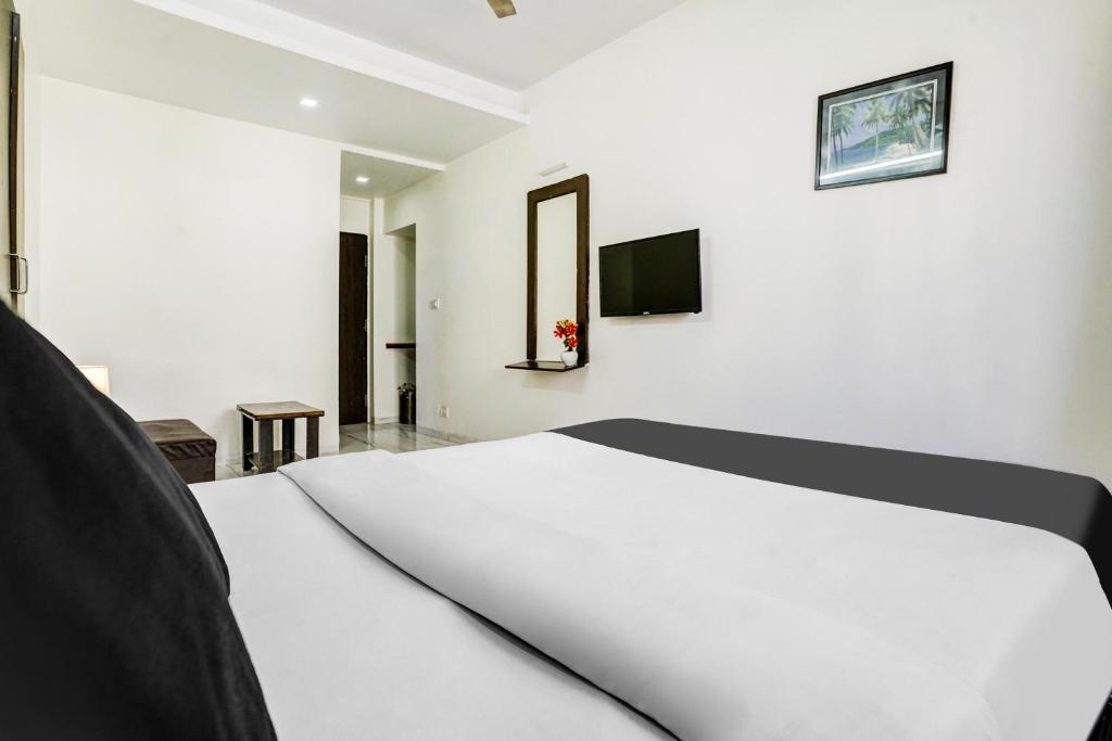 Postel nebo postele na pokoji v ubytování Hotel O Nashik Near Vijay Mamta Theatre Formerly Sahara Inn