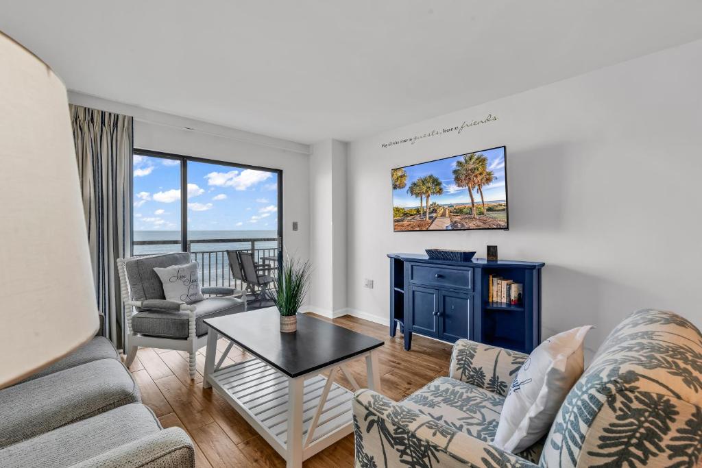 a living room with a couch and a table at Bluewater Resort 502 in Myrtle Beach
