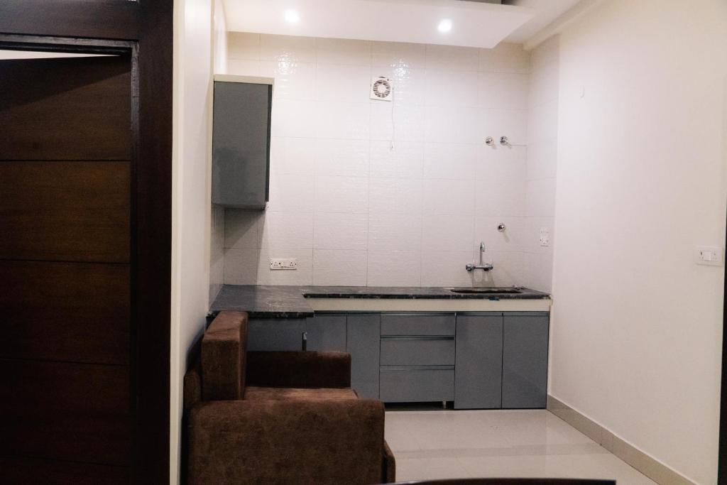 a kitchen with a sink and a counter top at Kesar The Saffron Homestay in Dehradun